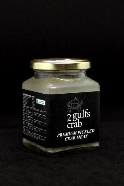 Black sticker on a jar with white logo, company name and details of the label