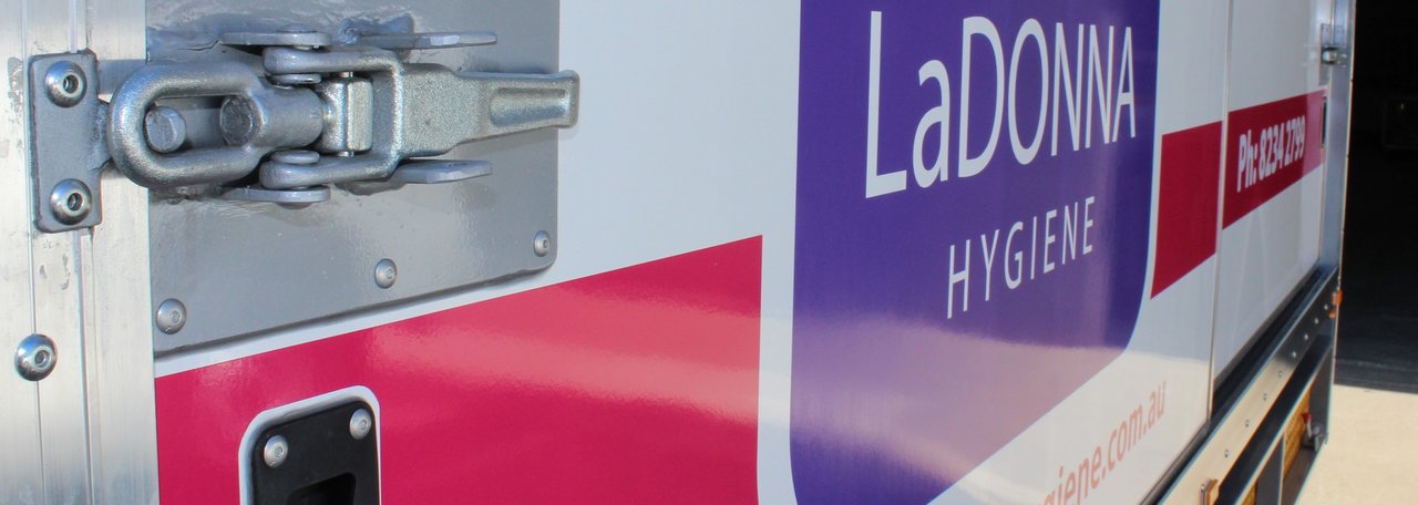 Pink and purple vinyl truck wrap, decals with company name and logo