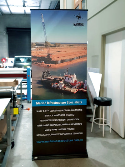 Banner sign with large colour photo in roll up and pull out frame for easy displays