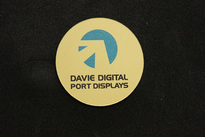 Brushed gold plastic circle badge with blue and black printed logo