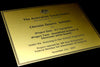 Engraved plack with black text on brushed gold finish plastic